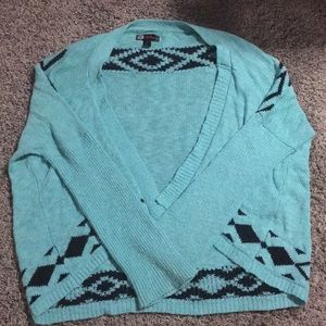 Turquoise sweater with patterns